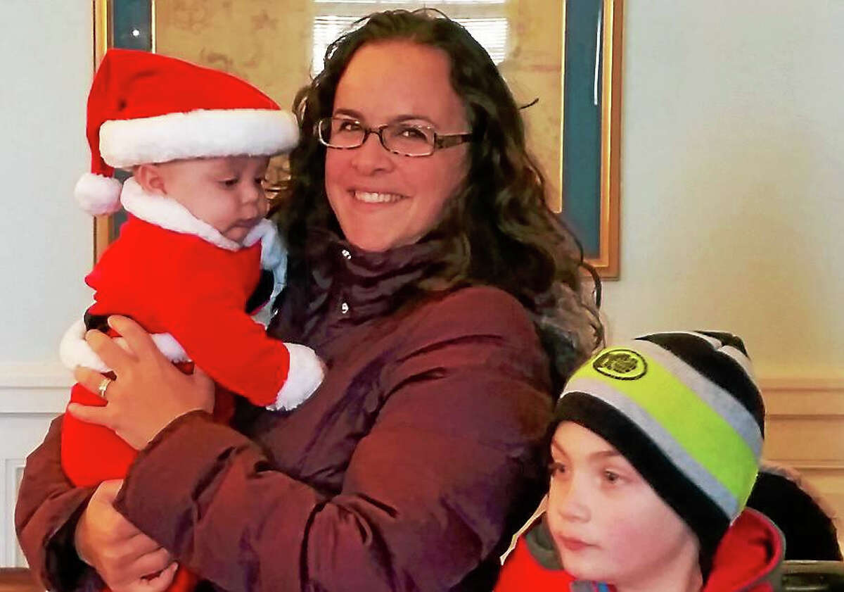 Leila Pesce of Northfield brought Ethan, four months old, in a Santa outfit, and Luke, 8, to visit Santa and Mrs. Claus at Union Savings Bank at 13 North Street in Litchfield as part of the Litchfield Holiday Stroll & Tree Lighting this past weekend.