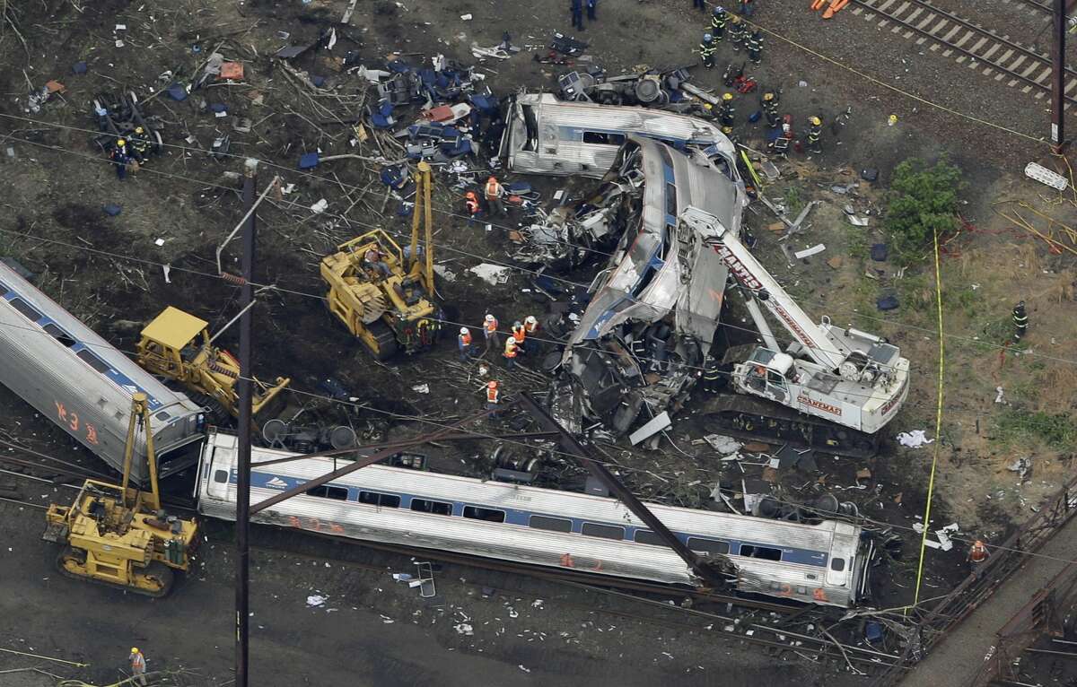 In this May 13, 2015 photo, emergency personnel work at the scene of a deadly train wreck in Philadelphia.