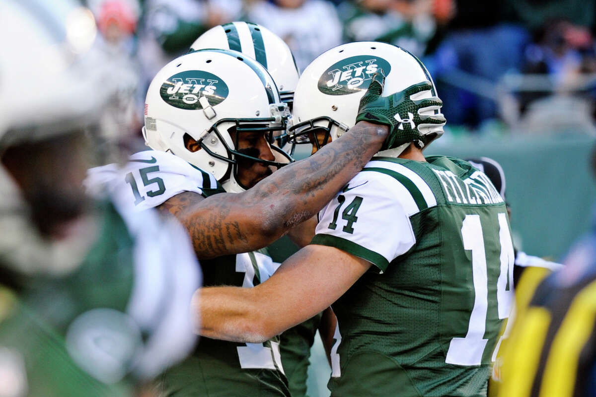 Jets wide receiver Brandon Marshall, left, and Ryan Fitzpatrick celebrate after the two connected for a touchdown during the first half Sunday against the Dolphins.