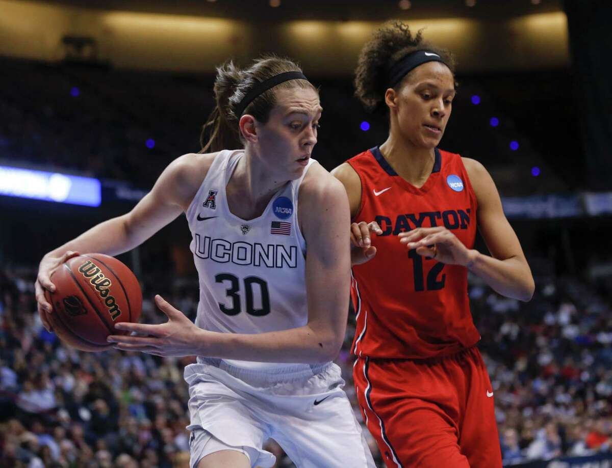 Connecticut forward Breanna Stewart (30) grabs a rebound in front of Dayton center Jodie Cornelie-Sigmundova, of France, during the second half of a regional final game in the NCAA women's college basketball tournament Monday, March 30, 2015, in Albany, N.Y. (AP Photo/Mike Groll)