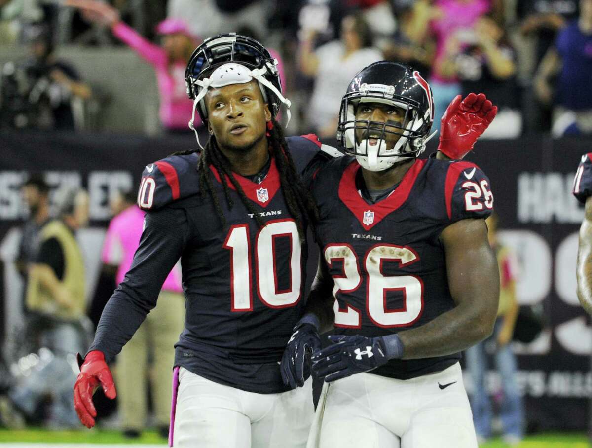Texans wide receiver DeAndre Hopkins (10) and running back Lamar Miller (26) walk off the field during the second half of Sunday’s game against the Indianapolis Colts.