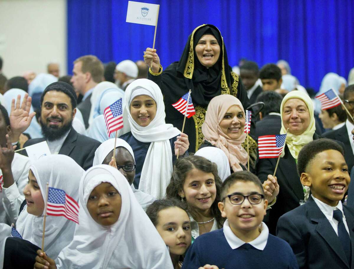 Children from Al-Rahmah school and other guests react after seeing President Barack Obama during his visit to the Islamic Society of Baltimore, Wednesday, Feb. 3, 2016, in Baltimore, Md. Obama is making his first visit to a U.S. mosque at a time Muslim-Americans say they’re confronting increasing levels of bias in speech and deeds.