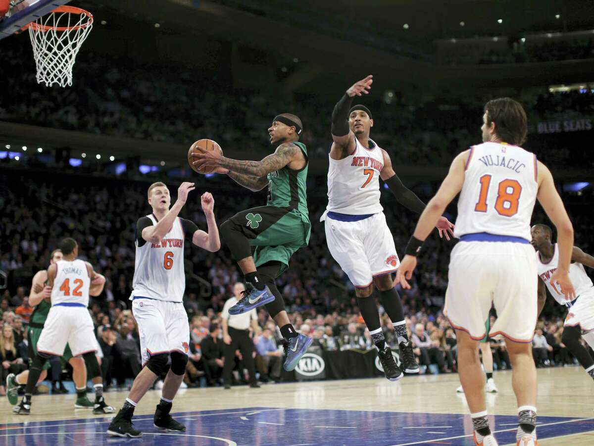 Celtics guard Isaiah Thomas drives through the Knicks defense during the third quarter Tuesday in New York. The Celtics won 97-89.