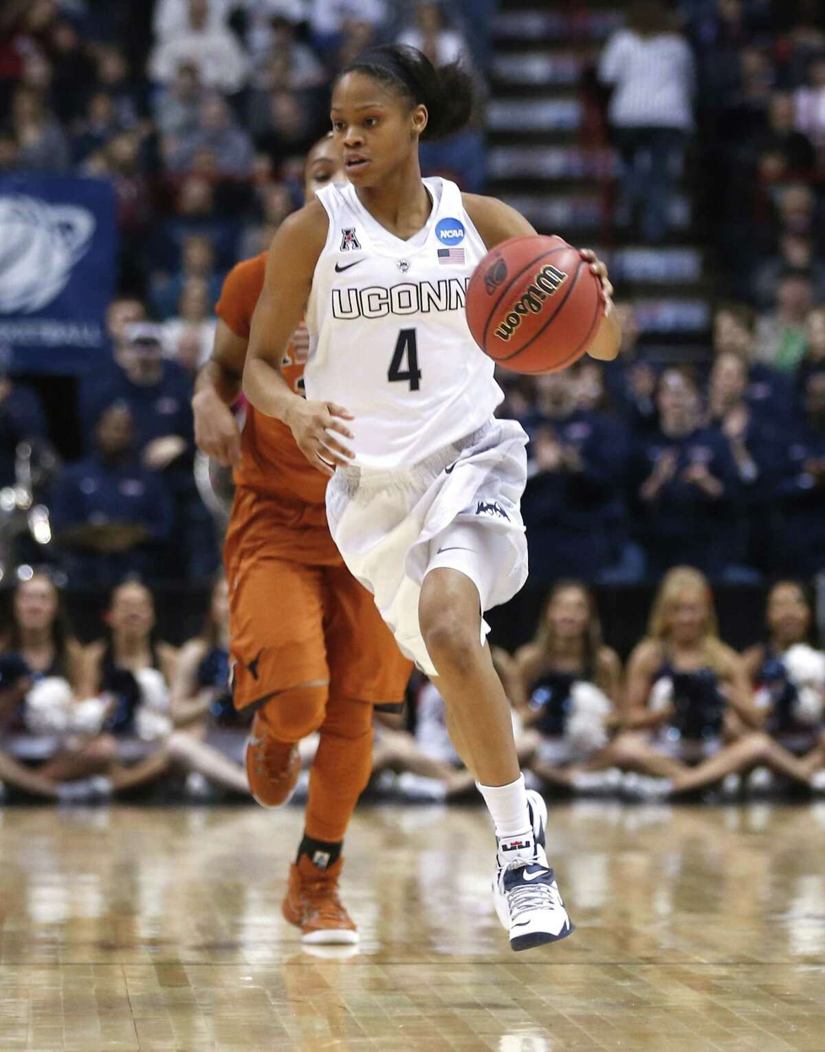 Connecticut guard Moriah Jefferson (4) moves the ball against Texas during the first half of a women's college basketball regional semifinal game in the NCAA Tournament on Saturday, March 28, 2015, in Albany, N.Y. (AP Photo/Mike Groll)