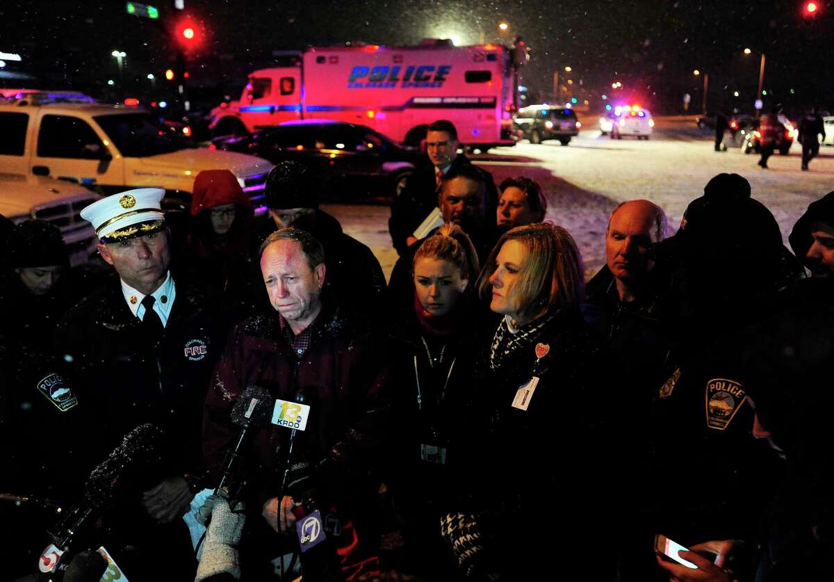 Colorado Springs, Colo., Mayor John Suthers, second from left, talks to media after a deadly shooting at a Planned Parenthood clinic Friday, Nov. 27, 2015, in Colorado Springs, Colo.