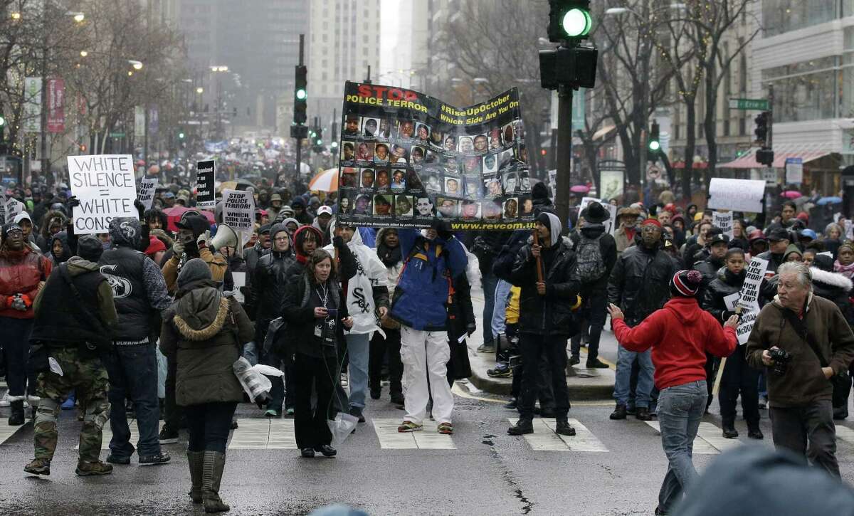 Protesters make their way up North Michigan Avenue on Friday, Nov. 27, 2015, in Chicago as community activists and labor leaders hold a demonstration billed as a “march for justice” in the wake of the release of video showing an officer fatally shooting Laquan McDonald.