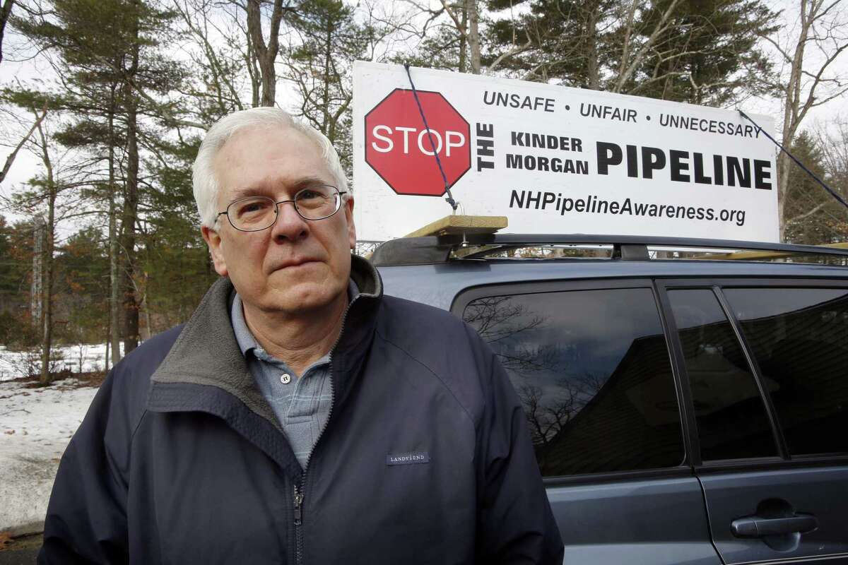 In this, March 26, 2015 photo, Homer Shannon poses at his home in Windham, N.H. The retired high-tech salesman is part of a 10-family group of neighbors opposed to a planned natural gas pipeline the would run right by his property behind him.