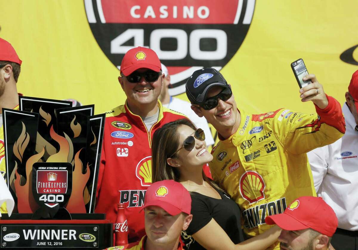 Joey Logano takes a selfie with his wife Brittany Baca after winning at Michigan International Speedway on Sunday.