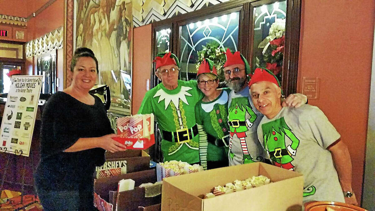Customer Dana Quinn of Thomaston bought popcorn from Santa’s elves, Warner Theatre volunteers Joe Bonetti of Torrington; Cindy Young of Harwinton; Mike Gardinello of Torrington; and Bob Lacko of Torrington at the theater’s third annual Holiday Movie Event, which included greetings by Santa and Mrs. Claus and a free screening of two classic holiday films “The Year Without a Santa Claus” and “Miracle on 34th Street.”