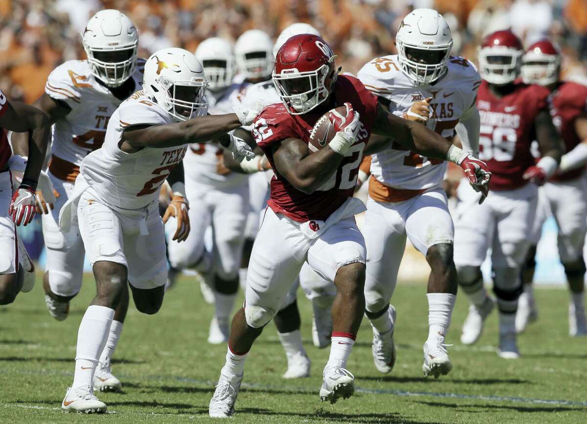 In this Oct. 8, 2016 photo, Oklahoma running back Samaje Perine (32) runs against Texas cornerback Kris Boyd (2) during an NCAA college football game in Dallas. Oklahoma faces Kansas State this week in a Big 12 game.