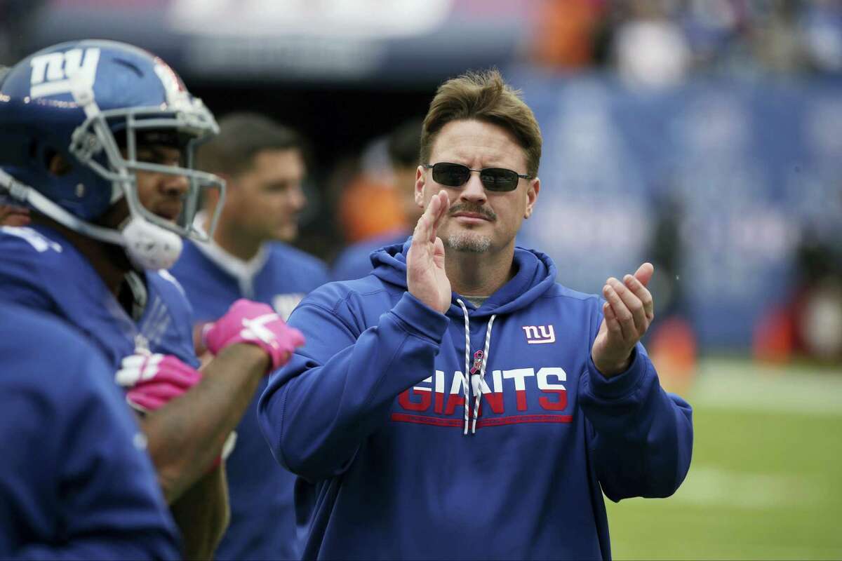 Giants head coach Ben McAdoo claps for his team before Sunday’s game against the Ravens.