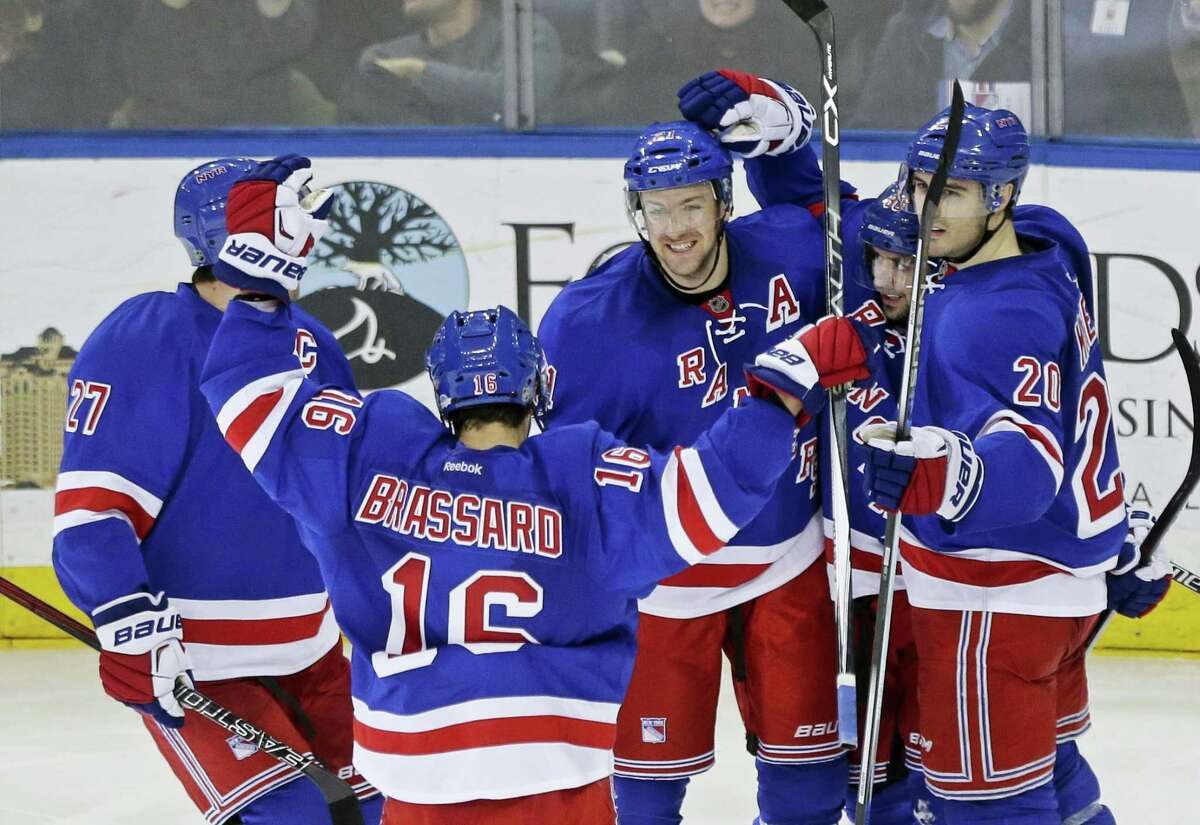 New York Rangers’ Ryan McDonagh (27), Derick Brassard (16), Chris Kreider (20) and Chris Kreider (20) celebrate with Mats Zuccarello after Zuccarello scored a goal against the Buffalo Sabres last week. The Rangers are in second place in the Metropolitan Division, but 14 points behind the Capitals.