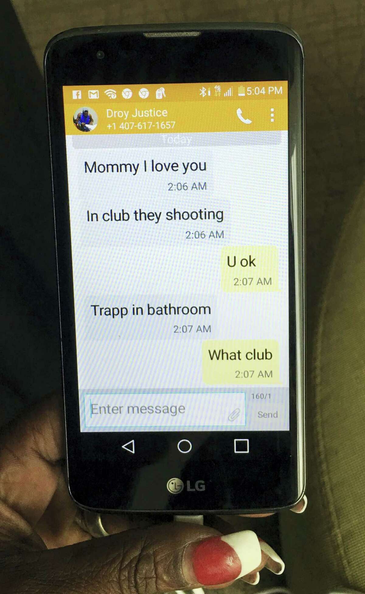 Mina Justice shows a text she received from her son Eddie Justice at Pulse nightclub during a fatal shooting in Orlando, Fla. on June 12, 2016. Justice hasn’t heard from her son since the messages.