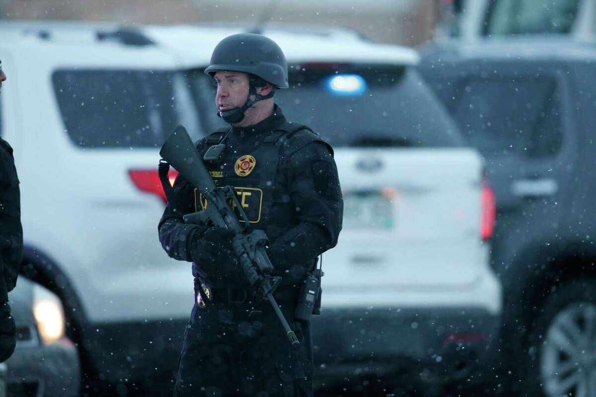 Police stand guard at the intersection of Centennial and Fillmore near a Planned Parenthood clinic Friday, Nov. 27, 2015, in Colorado Springs, Colo. A gunman opened fire at the clinic on Friday, authorities said, wounding multiple people.