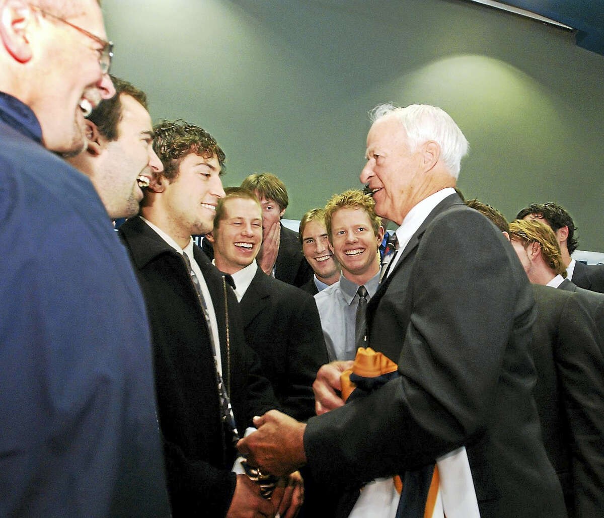 Hockey star Gordie Howe chats with the Quinnipiac hockey team after a press conference.