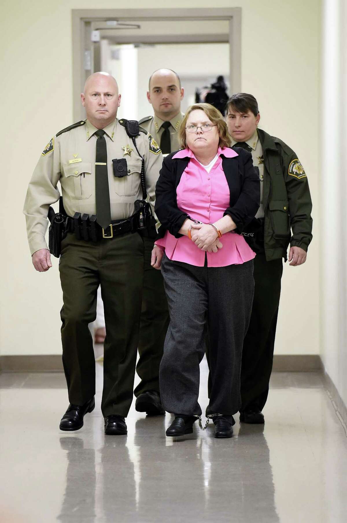 Joyce Hardin Garrard is led back to the Etowah County Detention Center in Gadsden, Ala. on Thursday, March 26, 2015, after a jury recommended she be sentenced to life in prison following her capital murder conviction. Circuit Judge Billy Ogletree will sentence Garrard on May 11 for the death of 9-year-old granddaughter, Savannah Hardin. (AP Photo/Gadsden Times, Eric T. Wright)