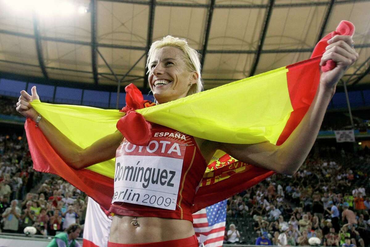 FILE - In this Monday, Aug. 17, 2009 file photo, Spain's Marta Dominguez celebrates after winning the gold medal in the Women's 3000m Steeplechase at the World Athletics Championships in Berlin. Former world champion runner Marta Dominguez has been banned for three years by the Court of Arbitration for Sport on Thursday, Nov. 19, 2015, and risks losing her 2009 steeplechase gold medal. CAS ruled after appeals by the IAAF and World Anti-Doping Agency challenging the Spanish athletics federation's decision last year to clear Dominguez of irregularities in her biological passport.