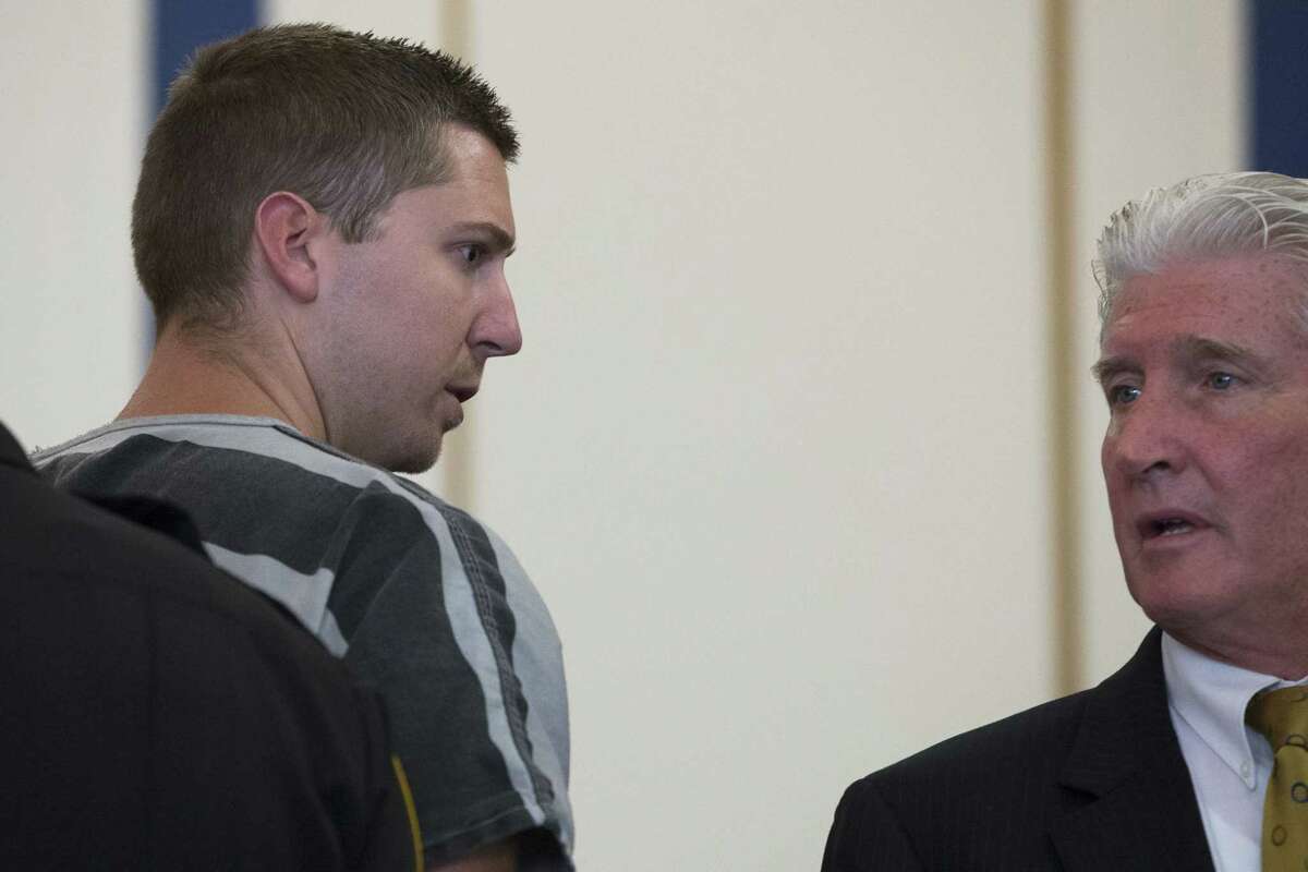 Former University of Cincinnati police officer Ray Tensing, left, glances towards his lawyer Stewart Mathews after appearing at Hamilton County Courthouse for his arraignment in the shooting death of motorist Samuel DuBose on July 30, 2015, in Cincinnati. Tensing, who was indicted and fired from his job on Wednesday, shot and killed Dubose on July 19.