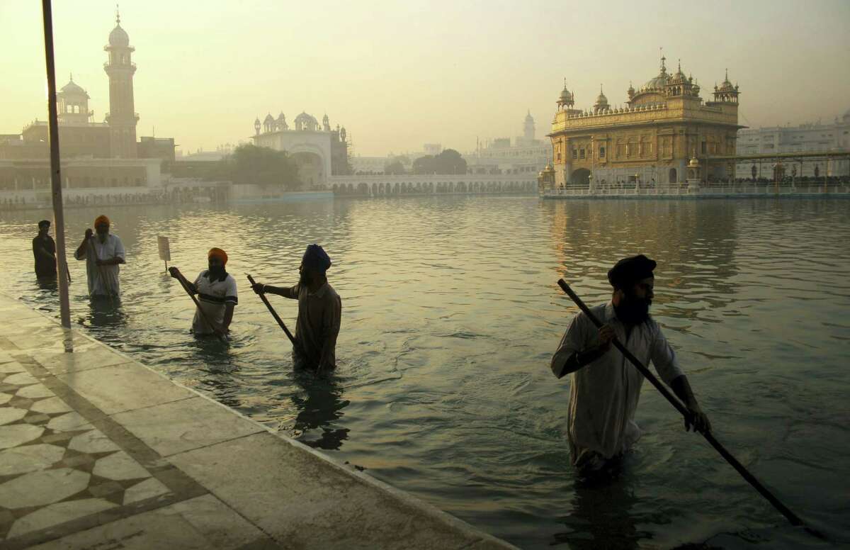 AP Photo/Sanjeev Syal, File In this Nov. 17, 2013, file photo, Indian Sikh devotees clean the tank early in the morning at the Golden Temple, on the birth anniversary of Guru Nanak, the first Sikh Guru in Amritsar, India. The chronic air pollution blanketing much of northern India is now threatening the holiest shrine in the Sikh religion, making the once-gleaming walls of the Golden Temple dingy and dull.