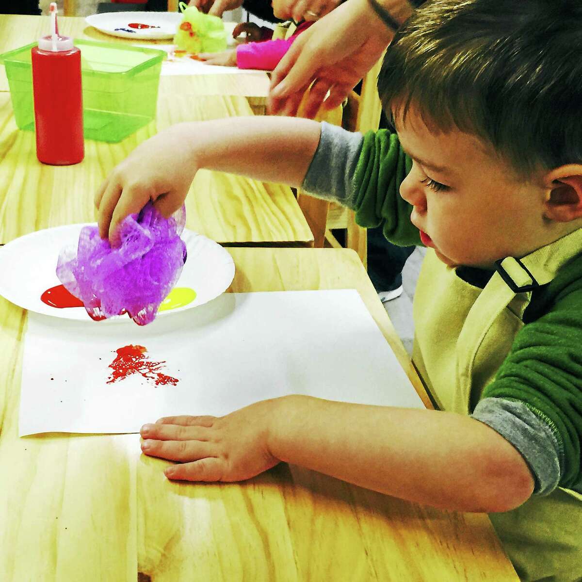 Contributed photoA child creates an abstract pattern during an art session at the Silly Sprout in Litchfield.