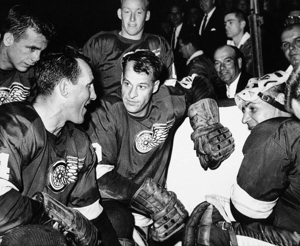 In this 1963 file photo, Detroit Red Wings star forward Gordie Howe is surrounded by teammates as he kneels after scoring his 544th goal to tie the National Hockey League all-time record.