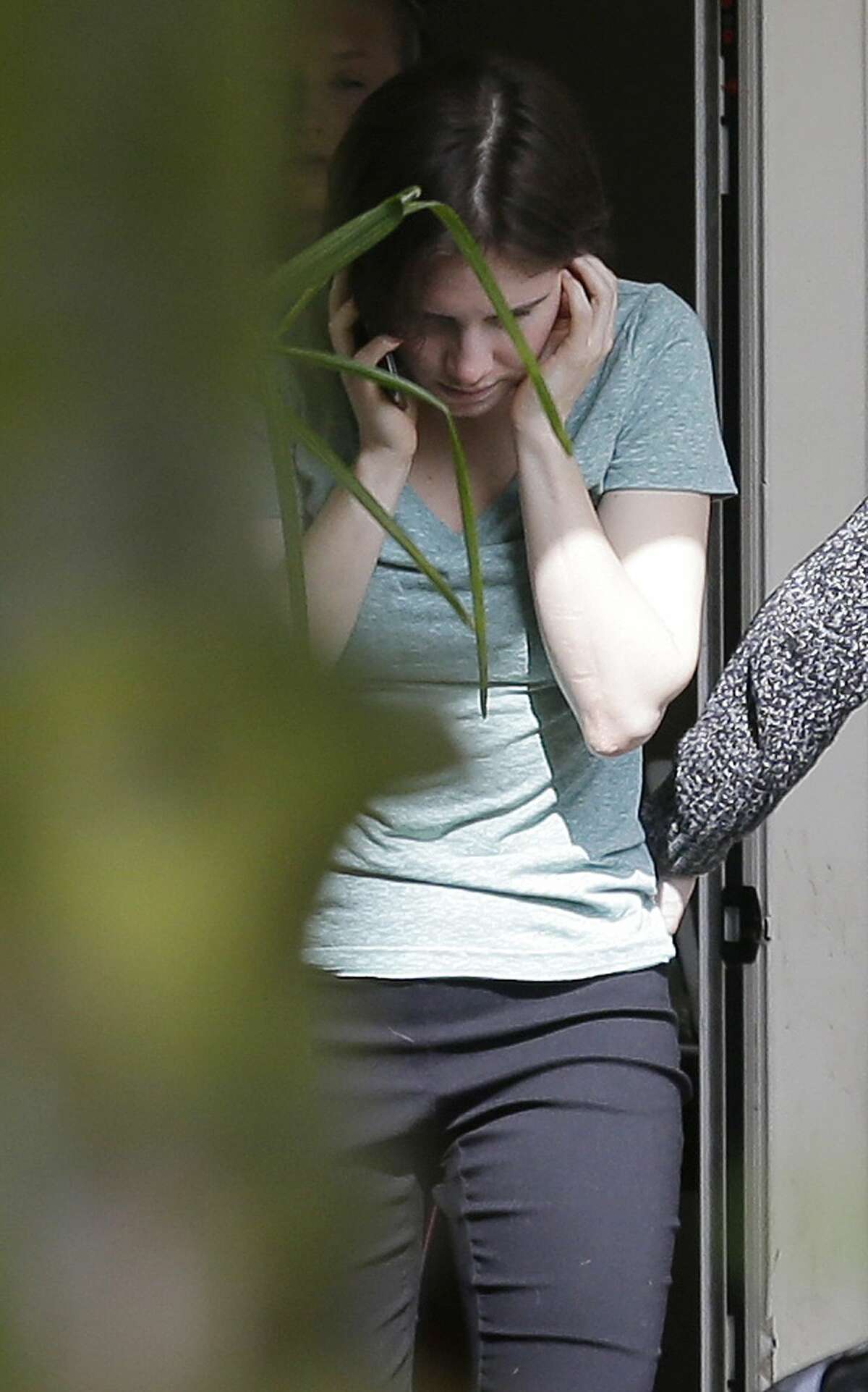 Amanda Knox talks on a phone in the backyard of her mother’s house Friday, March 27, 2015, in Seattle. Italy’s highest court overturned the murder conviction against Knox and her ex-boyfriend Friday over the 2007 slaying of Knox’s roommate, bringing to a definitive end the high-profile case that captivated trial-watchers on both sides of the Atlantic.
