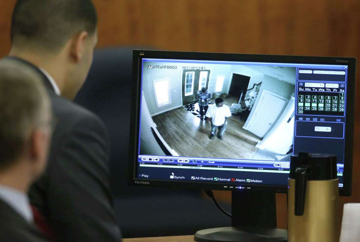 Aaron Hernandez, top left, sits with his defense attorney Charles Rankin, left, as surveillance video from June 17, 2013 is displayed on a monitor during his murder trial Thursday in Fall River, Mass.