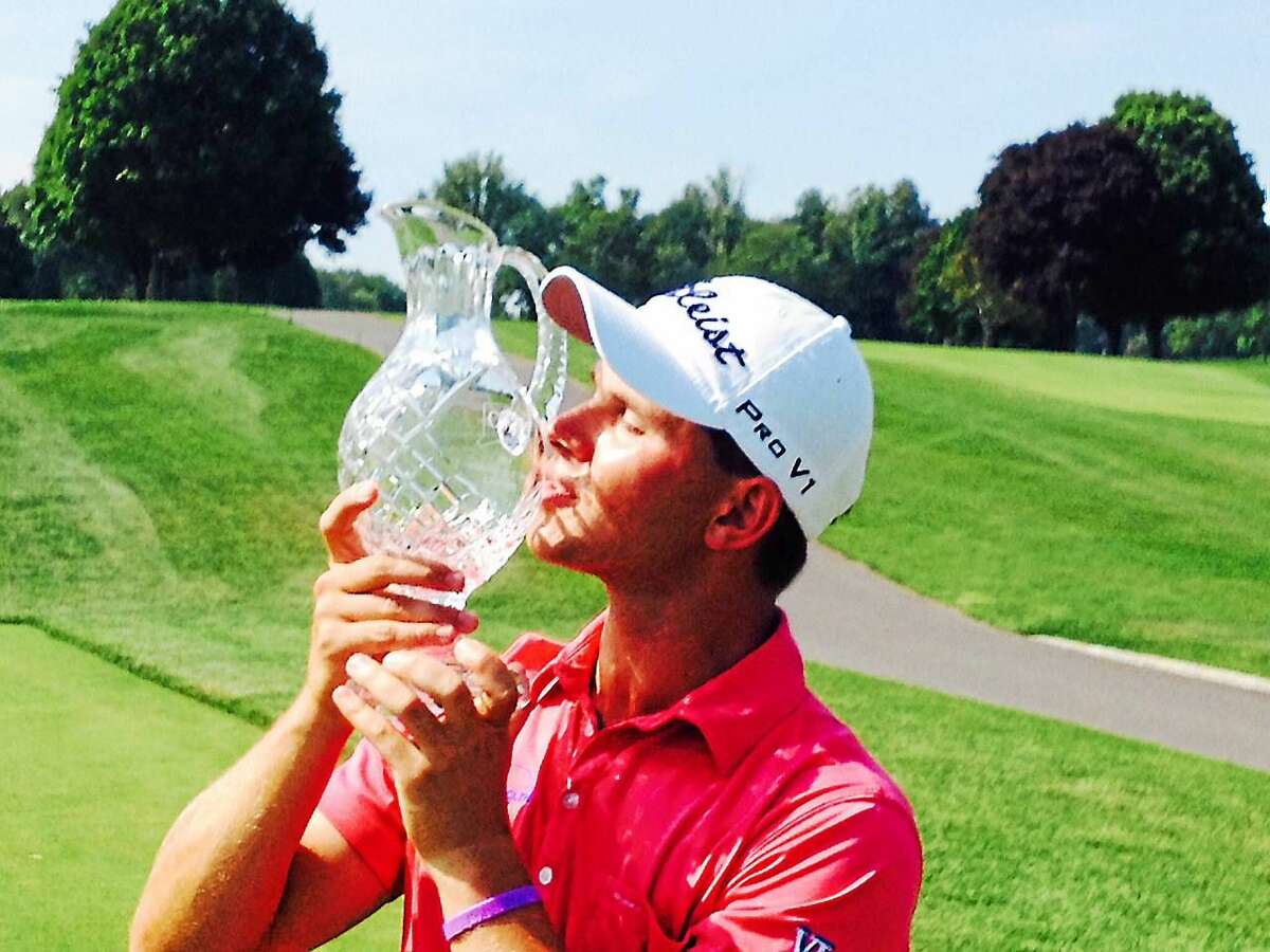 Cody Paladino kisses the crystal following his two-stroke win in the 81st Connecticut Open championship at The Patterson Club on Wednesday.