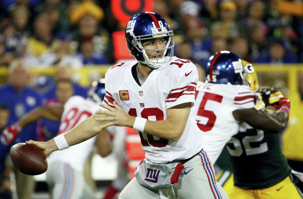 New York Giants’ Eli Manning throws during the first half last week’s game against the Packers.