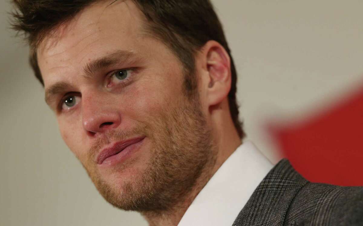 In this Jan. 19, 2014 photo, New England Patriots quarterback Tom Brady reacts to question during news conference after his team’s 26-16 loss to the Denver Broncos in the AFC Championship NFL football game in Denver. Brady’s four-game suspension for his role in using underinflated footballs during the AFC championship game last season has been upheld by NFL Commissioner Roger Goodell.