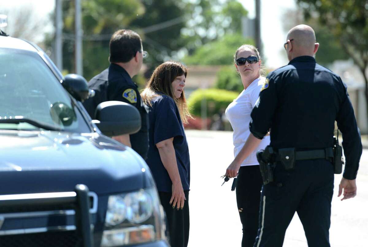 Two women talk with a San Jose police officers outside of the Senterville Terrace complex in San Jose, Calif., Wednesday, March 25, 2015. A man threatening to commit suicide unleashed a barrage of gunfire at the complex on Northern California officers called to check on him, killing officer Michael Johnson, a 14-year veteran of the San Jose Police Department on Tuesday. (AP Photo/San Jose Mercury News, Gary Reyes) MAGS OUT; NO SALES
