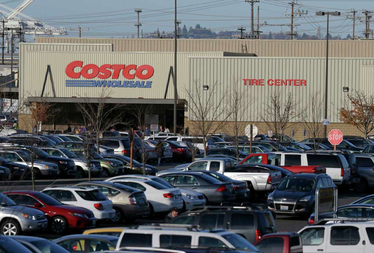 Cars fill the parking lot of a Costco store Nov. 24, 2015 in Seattle. Health authorities say chicken salad from Costco has been linked to at least one case of E. coli in Washington state.