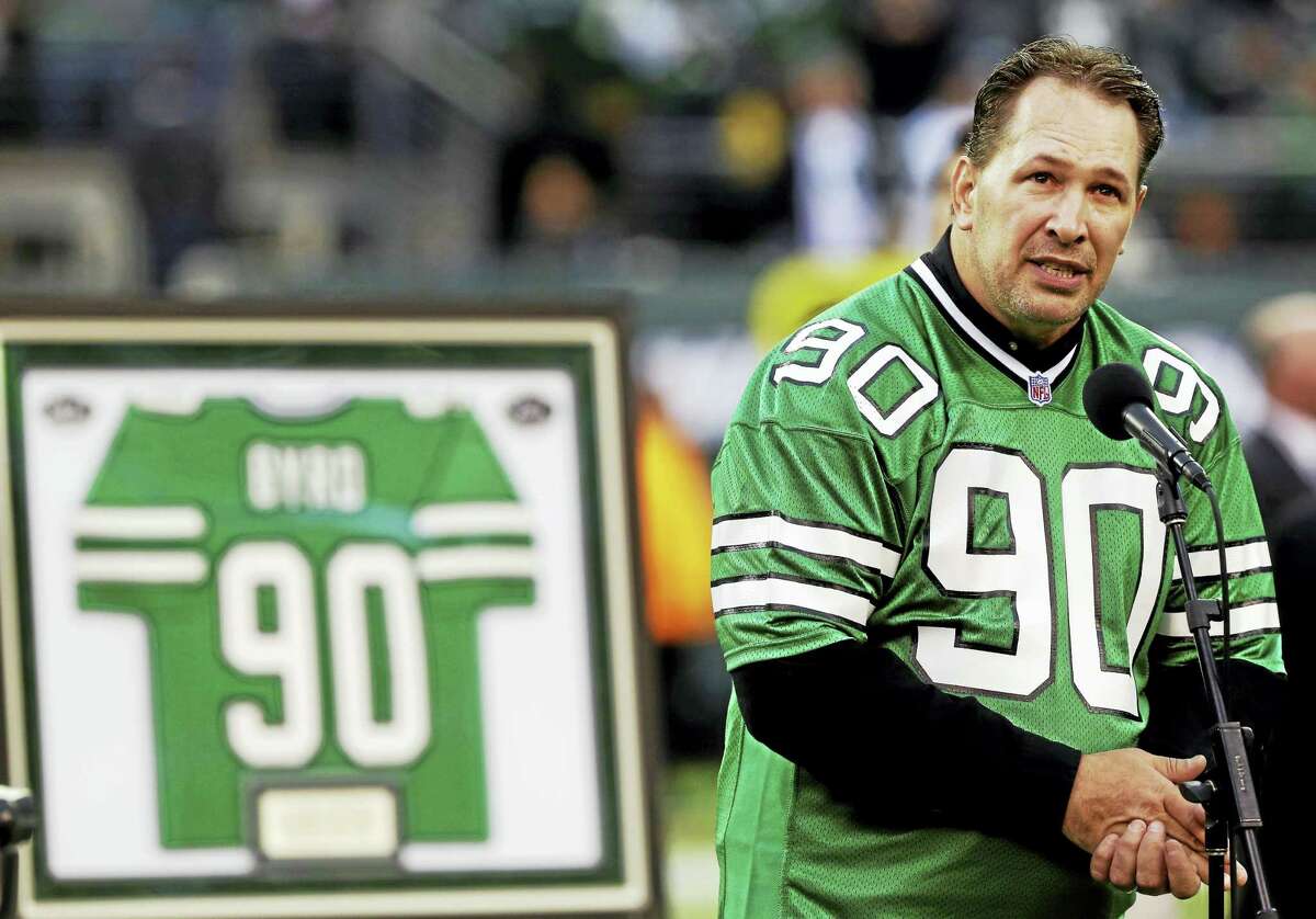 Dennis Byrd speaks during a halftime ceremony to retire his number in 2012.
