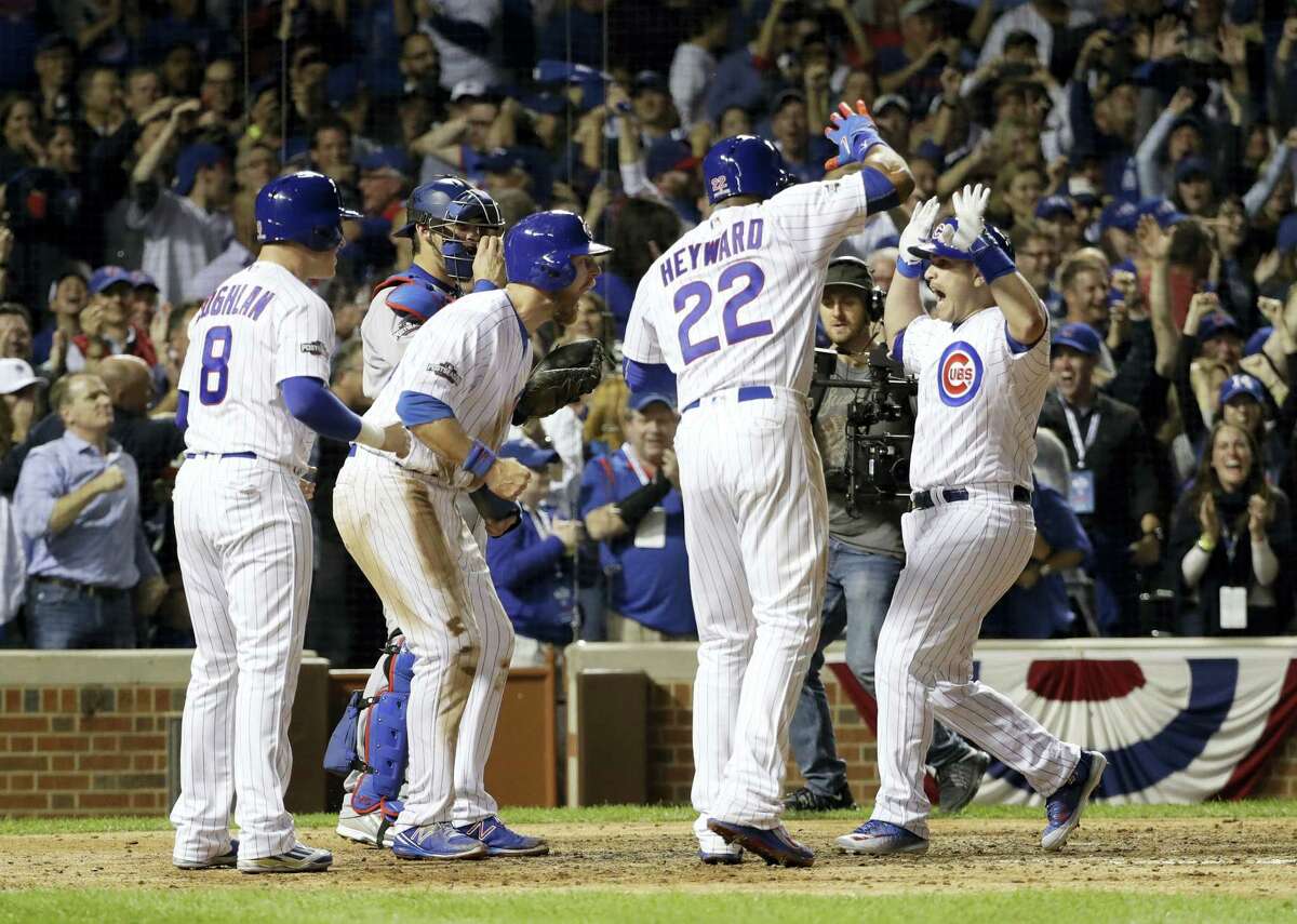 Chicago Cubs catcher Miguel Montero, right, celebrates after hitting a grand slam during the eighth inning of Game 1 of the NLCS on Saturday.