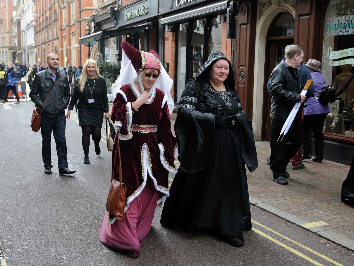 Two members of the public in traditional dress after attending a service for the re-reinterment of the mortal remains of King Richard III at Leicester Cathedral, Leicester, England, Thursday, March 26, 2015. The skeleton of King Richard III was discovered in 2012 500 years after he was killed in the Battle of Bosworth Field. (AP Photo/Rui Vieira)