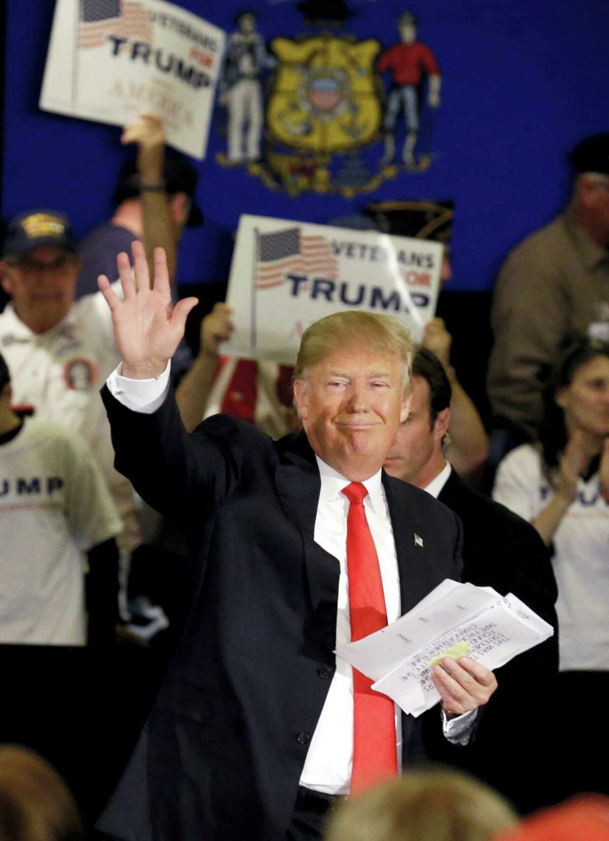 Republican presidential candidate Donald Trump waves to supporters as he leaves a campaign stop Wednesday, March 30, 2016, in Appleton, Wis.