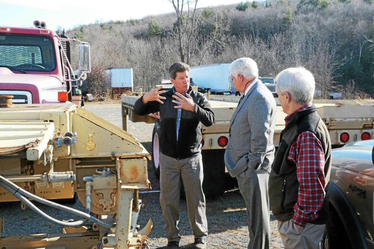 Martin Marola, president of Tru-Hitch, talks to U.S. Rep. John Larson and First Selectman Don Stein about the company’s plans to get a repairer’s license so it can refurbish its military vehicles, which see heavy use in Afghanistan and elsewhere.