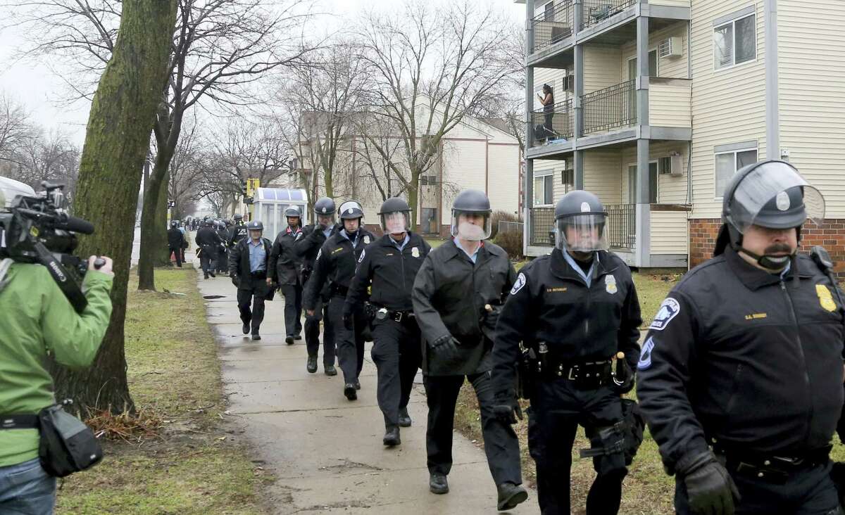 Minneapolis police officers head back toward the Fourth Precinct after being dispatched to head to the 1600 block of Plymouth Ave. N, where protesters had shut down the street Wednesday, March 30, 2016, in Minneapolis, after Hennepin County Attorney Mike Freeman announced that no charges will be filed against two Minneapolis police officers in the fatal shooting of a black man.
