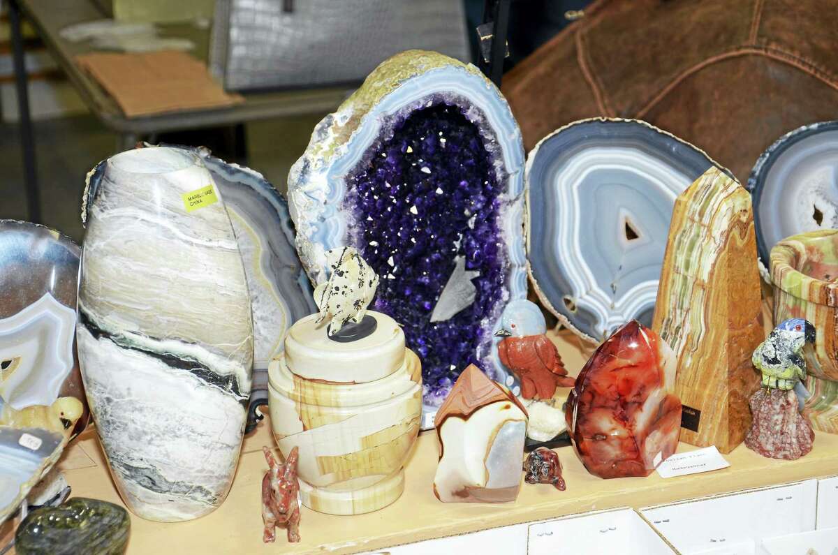 A table at a previous New Haven Mineral Club show, with an amythest geode from Brazil at center.