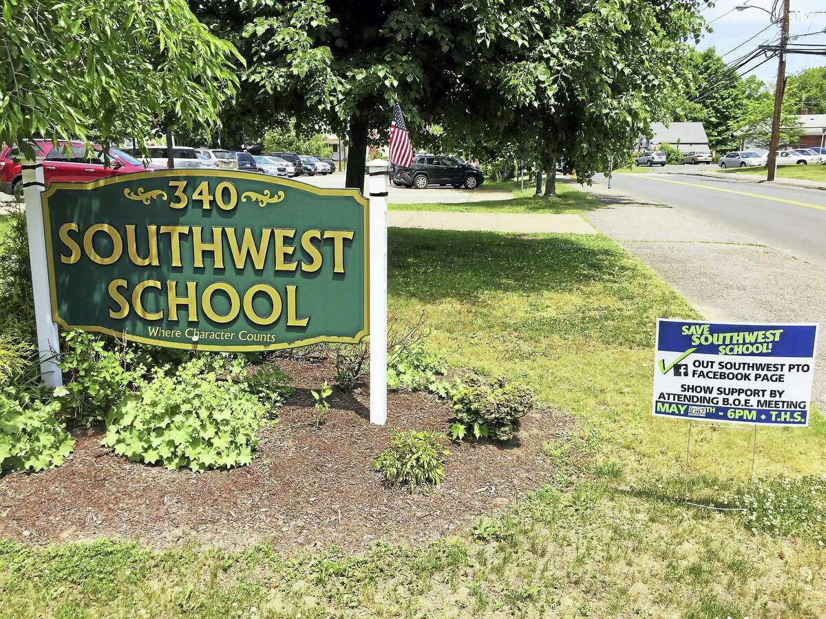 Ben Lambert - The Register Citizen Signs seen outside of Southwest School last week. The Torrington Board of Education voted against closing the institution after the current school year Wednesday.