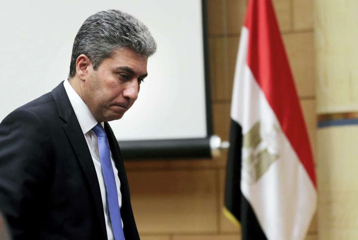 Egyptian Minister of Civil Aviation Sharif Fathy leaves a press conference at the Ministry headquarters in Cairo, Egypt on March 29, 2016. Fathy said seven people remain with the hijacker on the EgyptAir plane that has landed in Cyprus, four crew and three passengers.