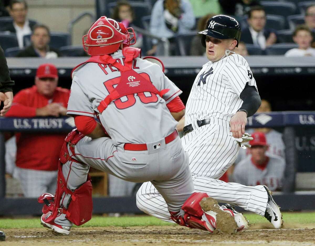 FRANK FRANKLIN II — THE ASSOCIATED PRESS New York Yankees’ Johnny Barbato slides past Los Angeles Angels catcher Carlos Perez to score on a Brett Gardner single during the fourth inning of the Yankees’ 12-6 victory Wednesday.