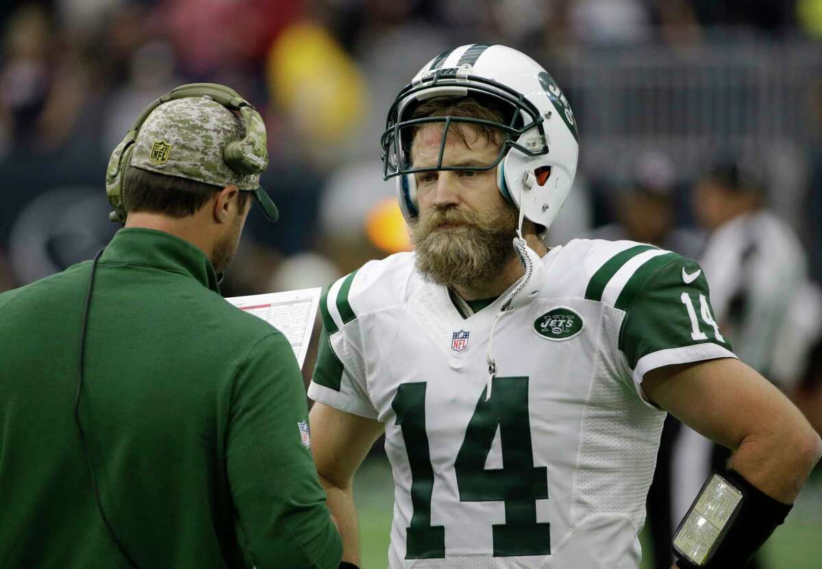 Jets quarterback Ryan Fitzpatrick talks on the sidelines during the second half of Sunday’s game against the Texans.
