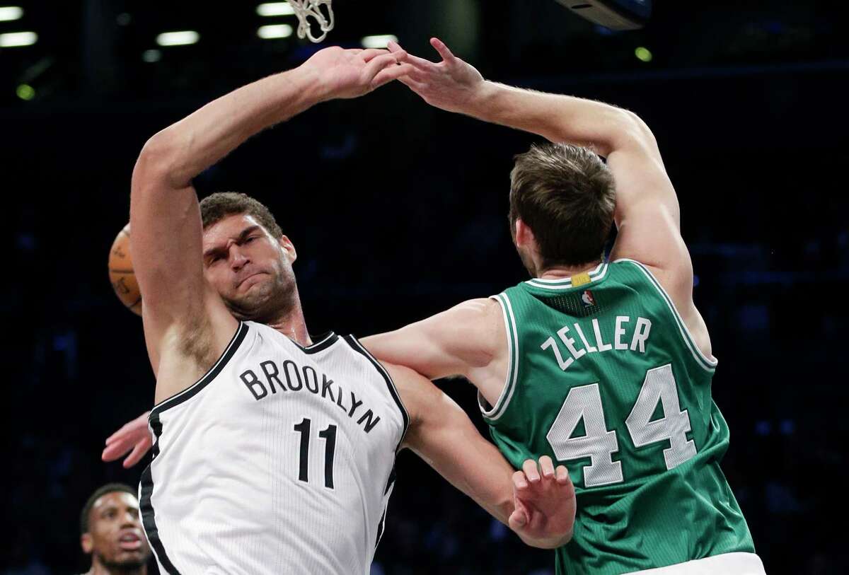 Nets center Brook Lopez blocks a shot by Celtics center Tyler Zeller during the third quarter Sunday.