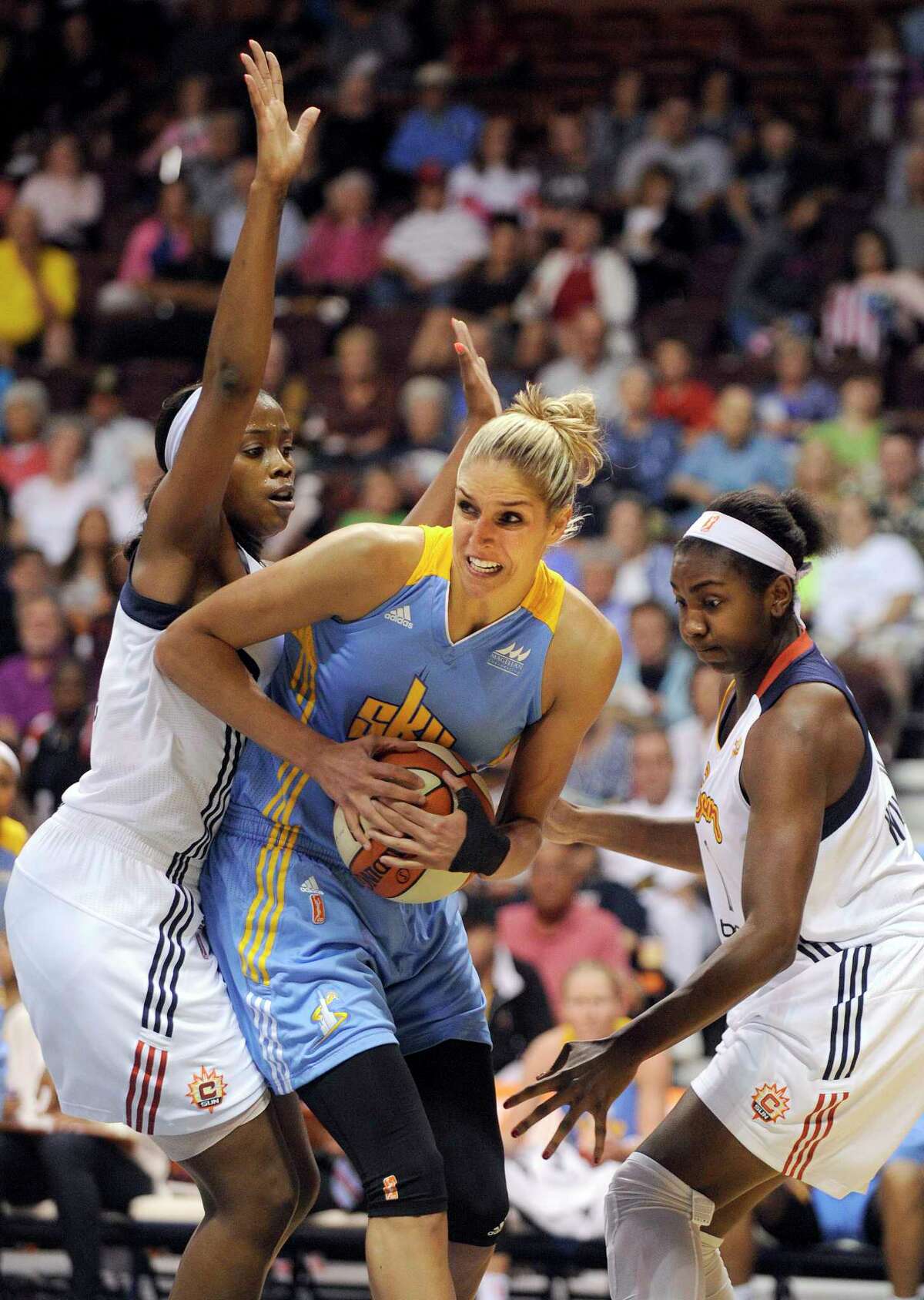 Chicago Sky's Elena Delle Donne , center, is guarded by Connecticut Sun's Camille Little, left, and Elizabeth Williams during the first half of a WNBA basketball game in Uncasville, Conn., on Thursday, July 2, 2015. (AP Photo/Fred Beckham)