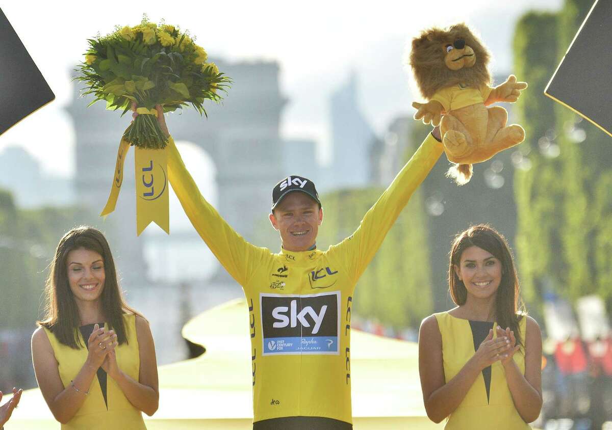 Britain’s Chris Froome celebrates as he stands on the podium after winning the Tour de France on Sunday.