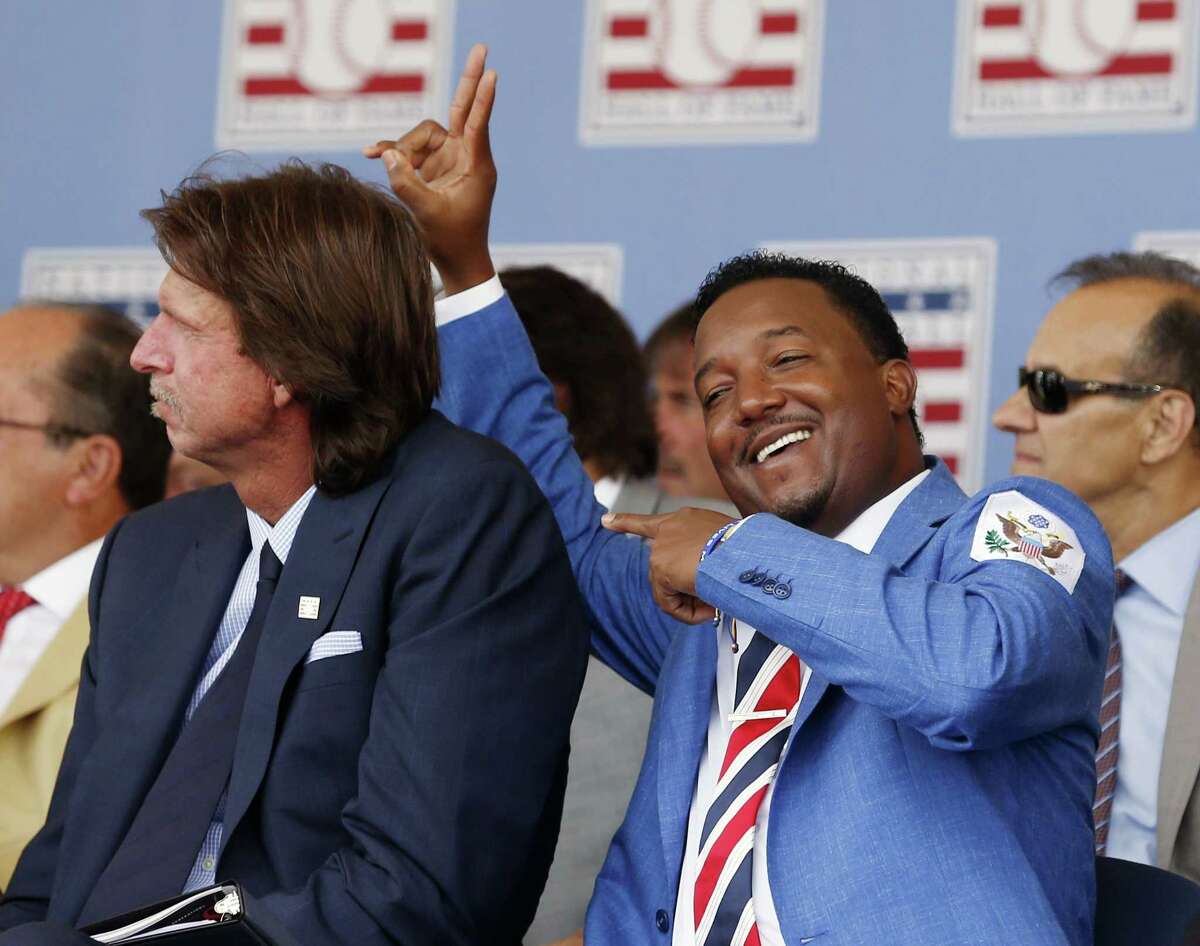 National Baseball Hall of Fame inductee Pedro Martinez, right, jokes with fellow inductee Randy Johnson during Sunday’s ceremony in Cooperstown, N.Y.