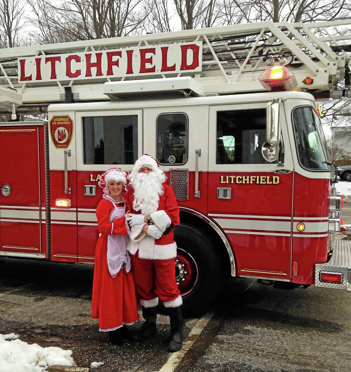 Santa gets a little help from local firefighters at the 2014 Litchfield Holiday Stroll and Tree Lighting.