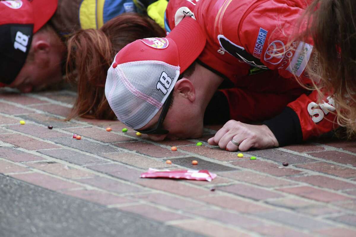 Sprint Cup Series driver Kyle Busch kisses the bricks on the start/finish line after winning the Brickyard 400 at Indianapolis Motor Speedway on Sunday.