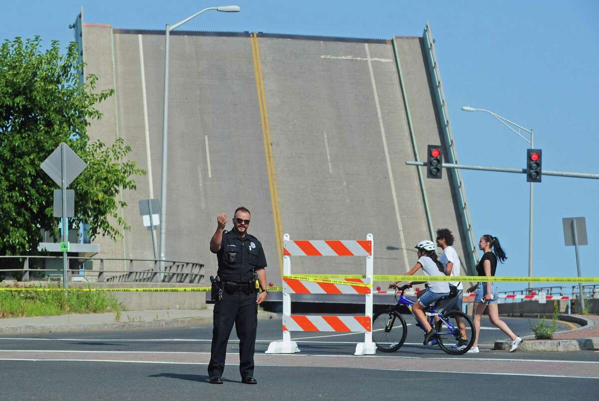 Police block off the Stroffolio Bridge to through traffic after one span of the draw bridge became stuck in the open position Saturday afternoon, August 26, 2017, in Norwalk, Conn.